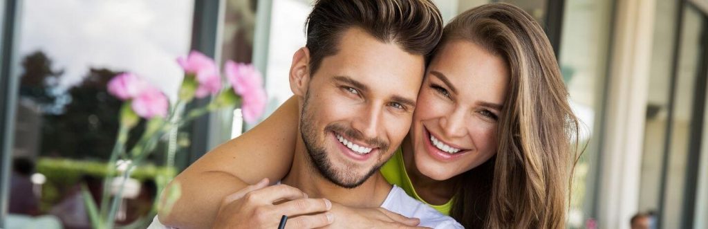 couple hugging happily smiling posing for photo
