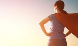 woman standing looking at sunny sky