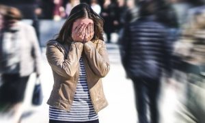 woman distressed in the street feeling overwhelmed