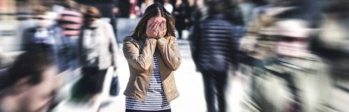 woman distressed in the street feeling overwhelmed