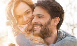 couple happily hugged smiles in beautiful sunny sky