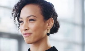 short black hair woman happy face smiles in office room