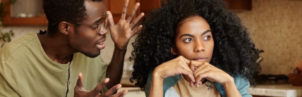 tanned skin man explains to curly black hair girl while she not listen with unhappy face