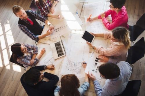 Many people in an office practicing gratitude