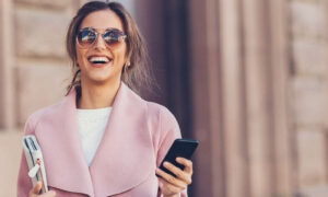Financial Wellbeing wealthy woman in a pink top feeling happy