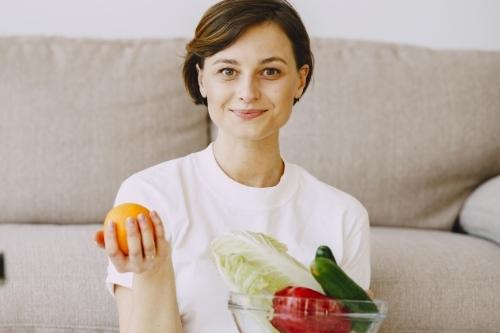 Content woman with healthy food in bowl