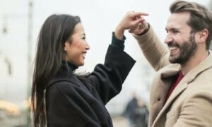 Couple Holding hands and happily dancing in broad daylight