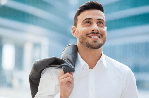 Confident happy young man in a corporate environment