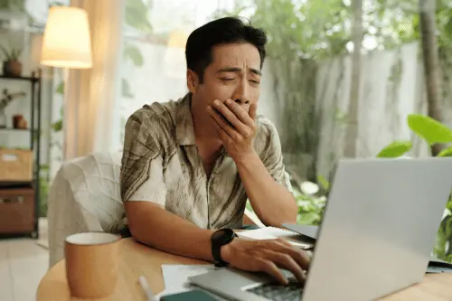 Digital Stress Exhausted man at work at computer
