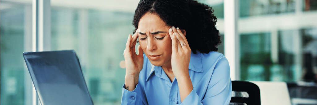 Digital stress caused for woman in blue shirt in office