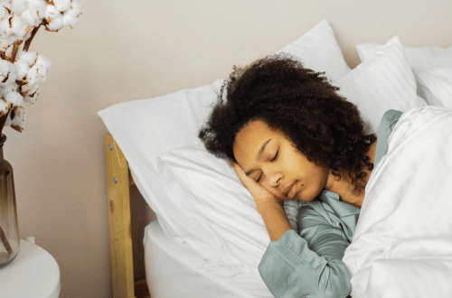 Self-Care for Students showing the importance of sleep with a student sleeping soundly in her bed.