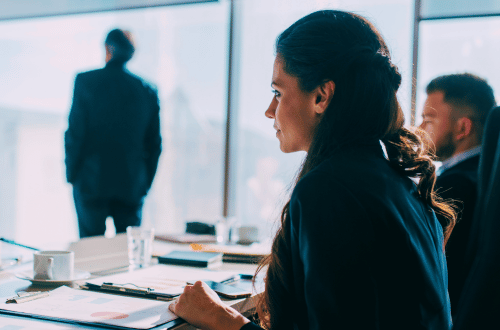 A woman sitting at a desk just about to go into a meeting doing Breathwork for Stress and Anxiety