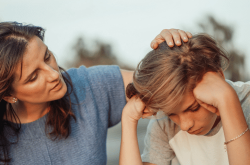 Parent comforting a child to relieve academic pressure
