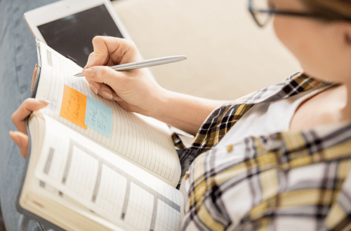 Student keeping a record in a diary to relieve academic pressure