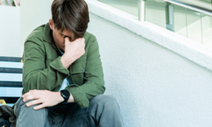 Stressed Student sitting on school stairs feeling academic pressure