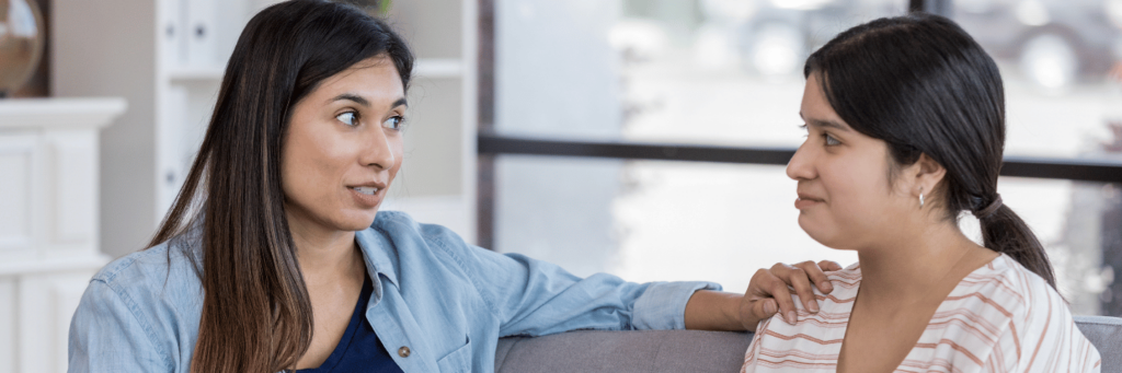 A woman sitting with her daughter setting boundaries with family