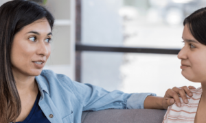 A woman sitting with her daughter setting boundaries with family