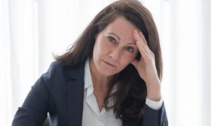 A professional woman suffering from psychosocial hazards at work