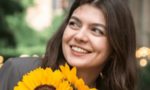 Colour and mood being uplifted as a happy woman holds yellow sunflowers