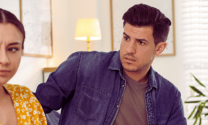Jealousy in relationships, as a man in a purple shirt confronts a woman in a yellow shirt