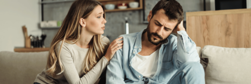 People-pleasing as a woman in a beige top comforts a man in a blue top and tries to do the right thing