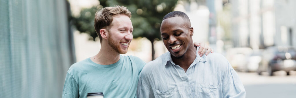 Two friends in their forties walking and laughing together in bright daylight, showing life after feeling stuck in life