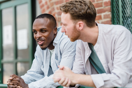 Two people in their forties having a calm, honest conversation in daylight, showing emotional boundaries being set kindly