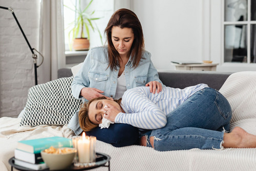 One woman listening closely to a friend in bright daylight, showing support as low energy emotions begin to shift