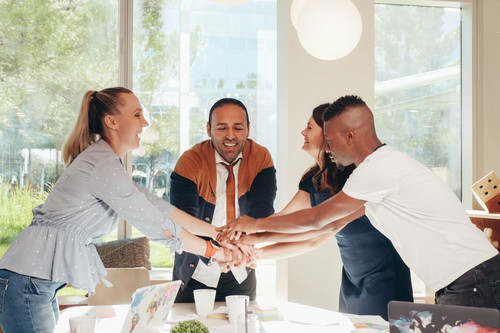 Colleagues at ease together in a bright modern office, showing emotional boundaries working well at work