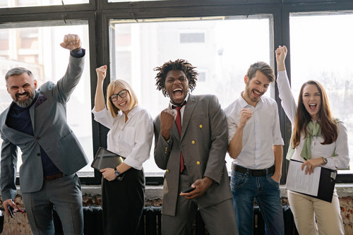 Colleagues at ease around a table in a bright modern office, showing what work looks like when fear of rejection loses its grip