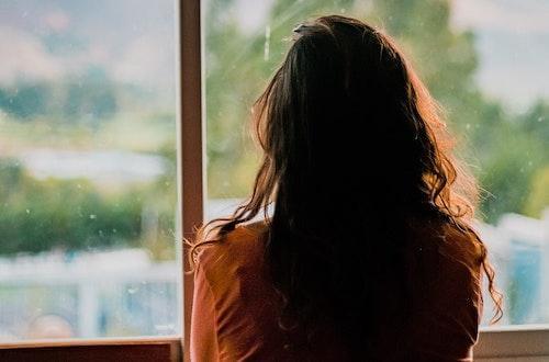 Woman staring out of a window