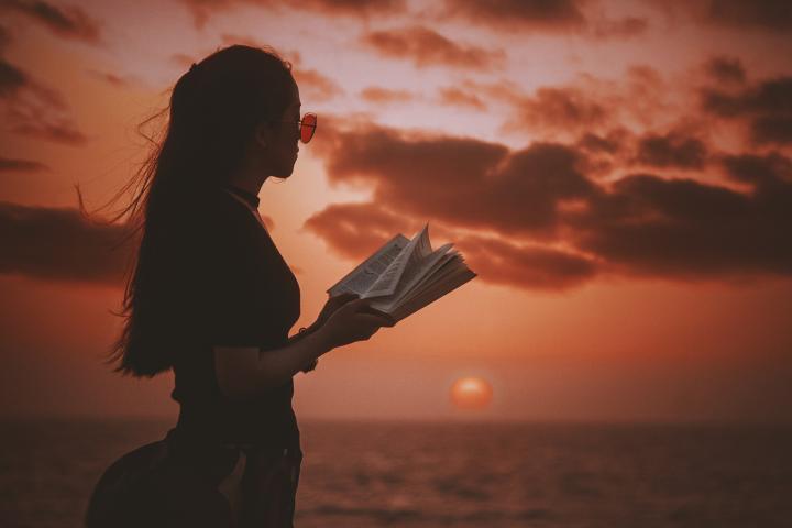 A woman reading by the sea