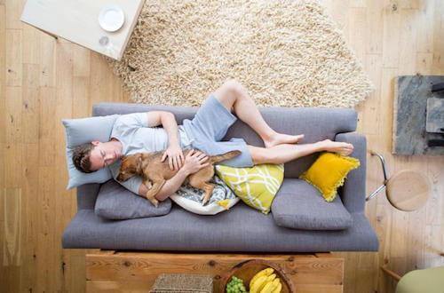 man sleeping with his dog