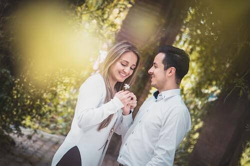 man giving woman a flower