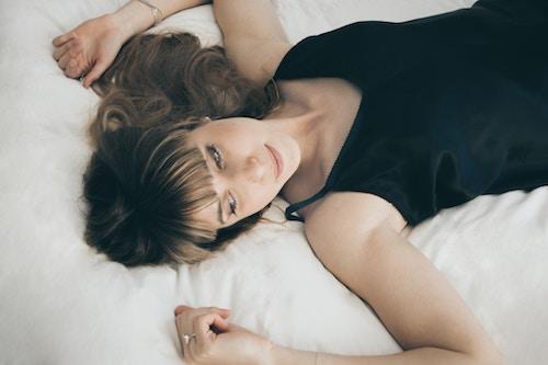 woman lying down feeling emotions paying attention to body
