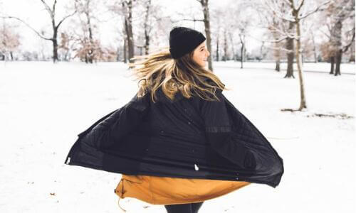 Woman twirling in snow