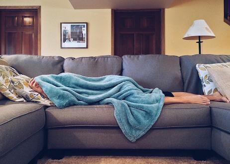 Person sleeping underneath blanket