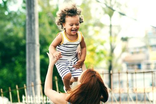 child playing with mother happy