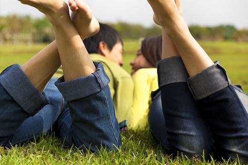 couple laying on the grass together