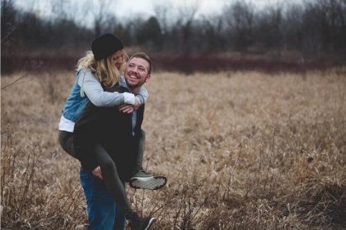 man giving woman a piggy back