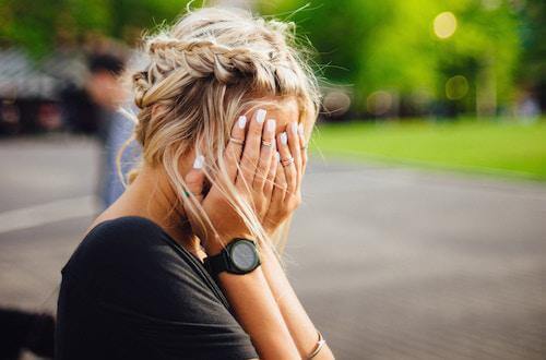 Woman hiding her face in her hands