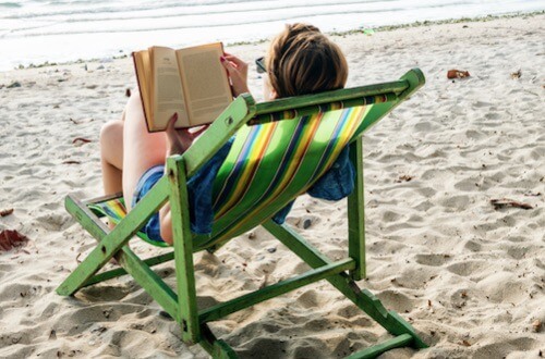 woman reading on the beach