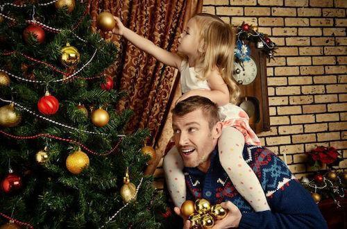 Father and Daughter Decorating Christmas Tree