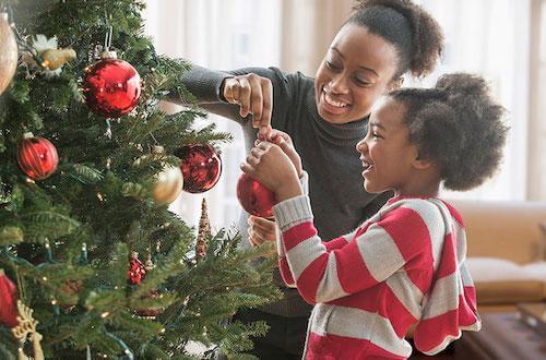 Mother and Child decorating Christmas Tree
