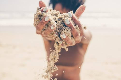 Woman holding sand