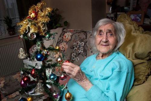 Old Woman Holding Christmas Tree