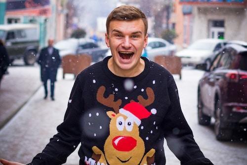 a happy man with a reindeer sweater