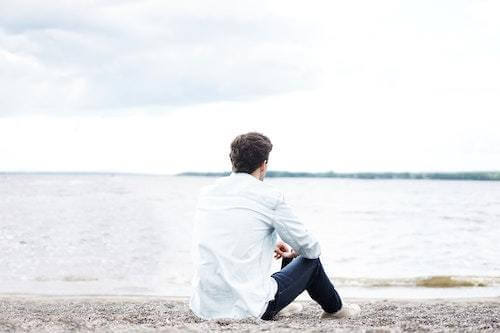 man sitting alone on a beach