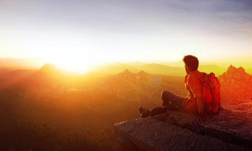 man looking out on sunrise 