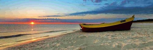 boat on sand nearby beach in blue sunset sky